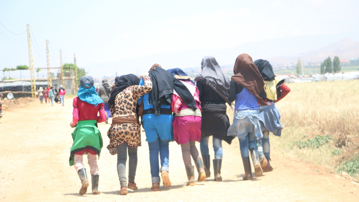 Syrian women walking back from the fields after a days work 