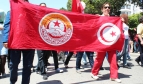 Demonstrators carry a UGTT banner