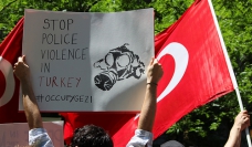 Photo by Elif Altinbasak - Turkish flag + banner calling to stop police violence