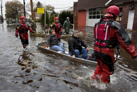 People being rescued from flooding in a boat