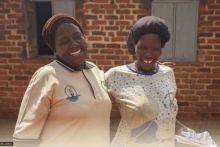 A health worker and a patient walking together, smiling
