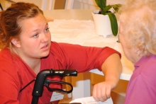 A young care worker with an elderly patient