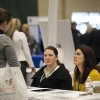 Unemployed person talks to advisors at a job fair