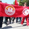 Demonstrators carry a UGTT banner